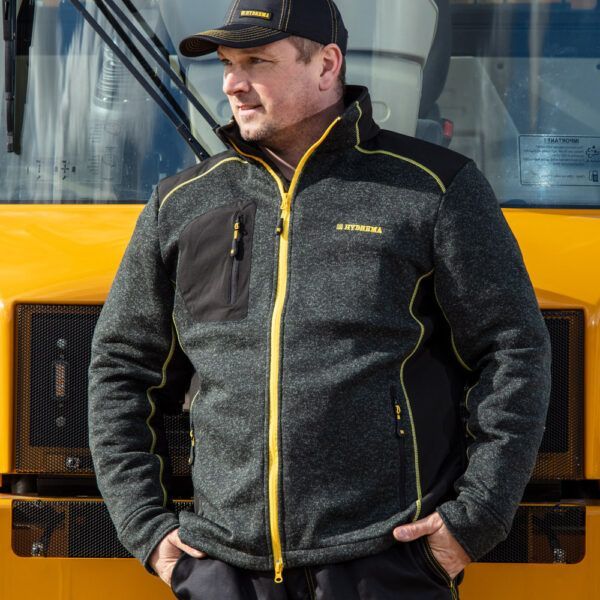 man wearing hydrema casual jacket in front of hydrema dump truck